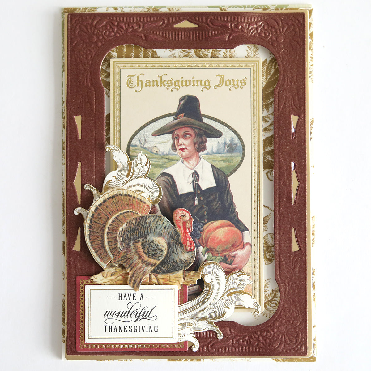 Send warm holiday wishes with the Fall Thanksgiving Postcards and Embellishments. This handmade card features a pilgrim woman holding pumpkins, a delightful turkey illustration, and heartfelt messages: “Thanksgiving Joys” and “Have a wonderful Thanksgiving.” Perfect for autumn paper craft enthusiasts, these postcards capture the charm of classic Thanksgiving greetings with beautiful fall-inspired details.