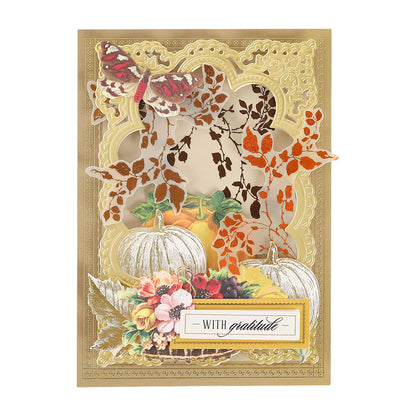 Greeting card crafted with the Flourish and Vine Gilded Hot Foil Plates, featuring an embossed gold frame, pumpkin and floral arrangement, butterfly, autumn leaves, and a “With gratitude” label. Ideal for paper crafting enthusiasts and compatible with the Anna Griffin Empress Gild.