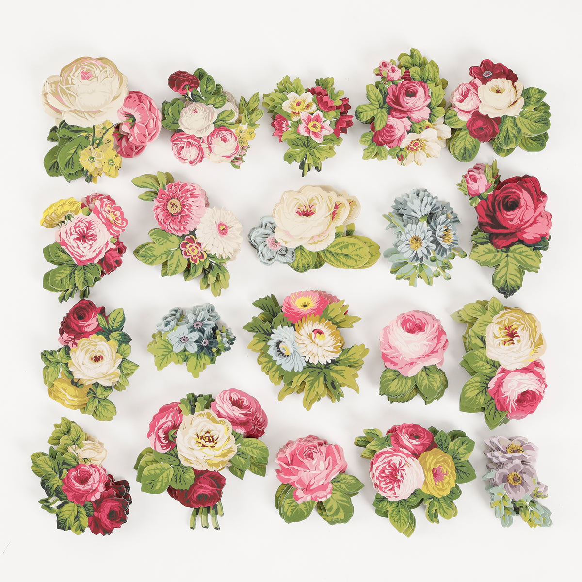 Twenty Cottage Roses Embellishments, showcasing a variety of pink, red, white, blue, and yellow flowers accented with green leaves, are evenly arranged on a white background for a charming floral embellishment effect.
