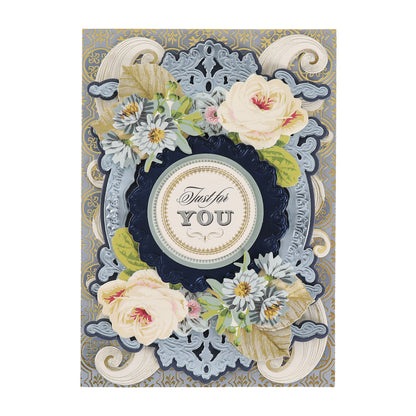 Greeting card adorned with ornate blue and gold patterns, white roses, daisies, and floral accents from the Cottage Roses Embellishments collection, featuring a central circle that reads “Just for YOU” in elegant script.