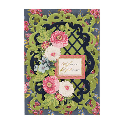 Ornate greeting card with layered green and black cutouts, pink and white flowers, and a central message reading “kind heart, bright spirit” on a floral background, elegantly accented with Cottage Roses Embellishments for added dimension.