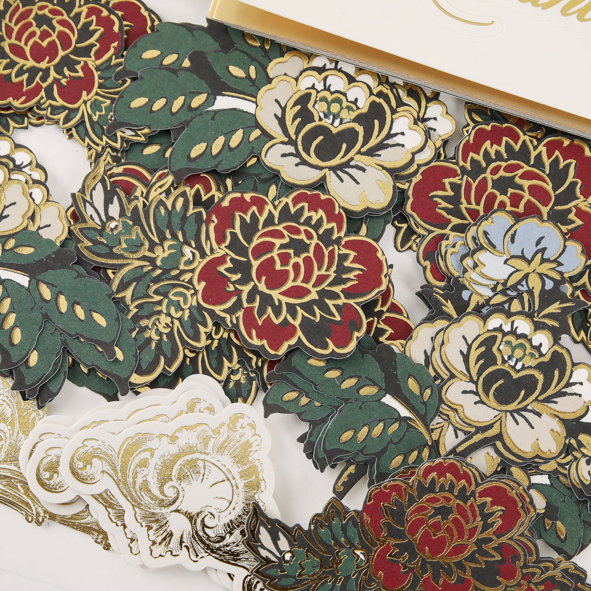 A set of detailed floral stickers from the Venetian Ultimate Paper Crafting Collection, featuring gold trim and a greeting card partially visible at the top right.