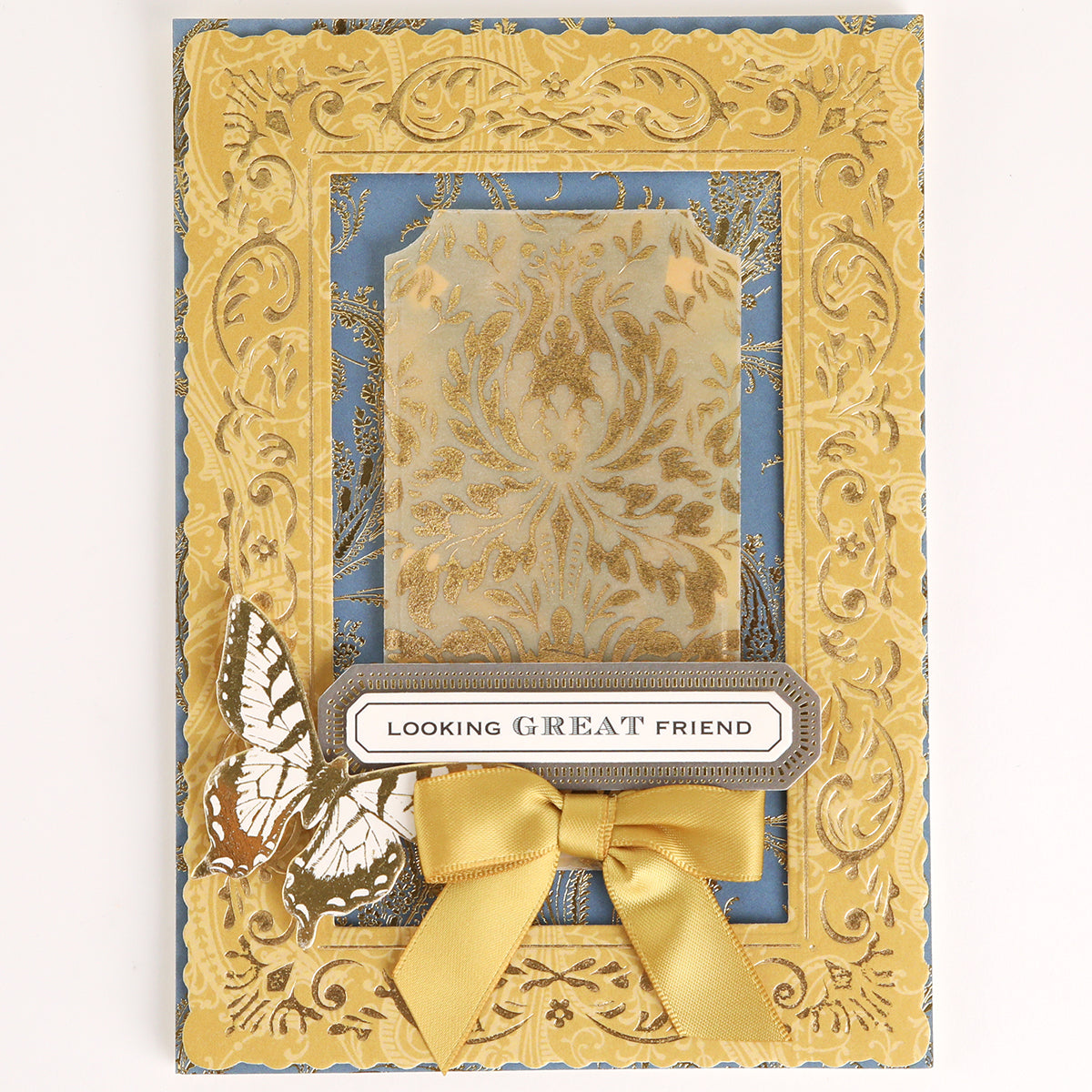 Venetian Gilded Frame Pattern Foil Plates feature an ornate gold embossed frame, damask center, yellow bow, butterfly, and “LOOKING GREAT FRIEND” label on blue.