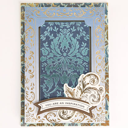 Venetian Gilded Frame Pattern Foil Plates feature ornate gold and blue floral patterns, Venetian artistry, and an inspiring cutout accent with a central banner.