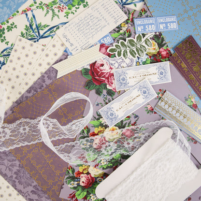 Assorted patterned papers, vintage labels, handwritten note, lace ribbon, and two enclosure tickets arranged on a flat surface—perfect inspiration for your next project with Anna Griffin | Create Fall 2026 or to share in our creative community and upcoming craft classes.