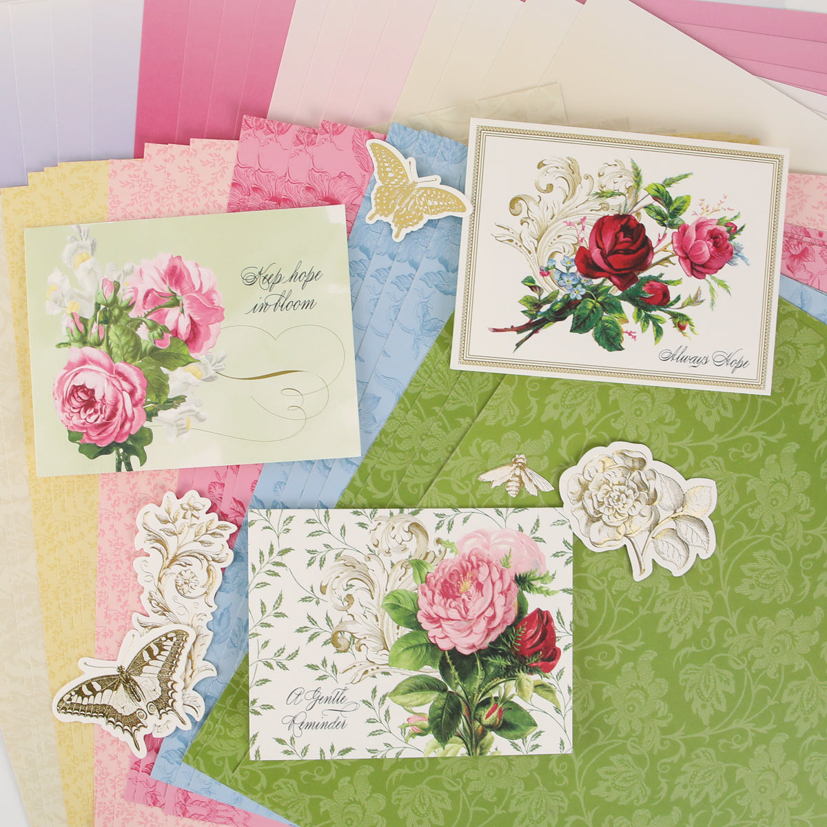 Assorted floral-themed greeting cards and paper sheets with butterfly and flower cutouts, arranged on a flat surface—perfect inspiration for anyone using Anna Griffin | Create Fall 2026 or sharing ideas in your local craft classes and creative community.