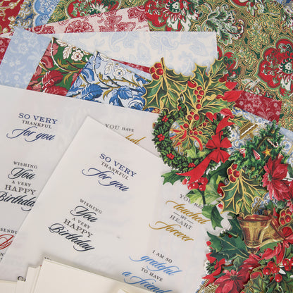 Assorted holiday and floral-themed papers from the Anna Griffin | Create Fall 2026 collection, featuring printed messages like “Happy Birthday” and “Thank you,” arranged in a layered, overlapping fashion—perfect for inspiring your next craft class or sharing with your creative community.
