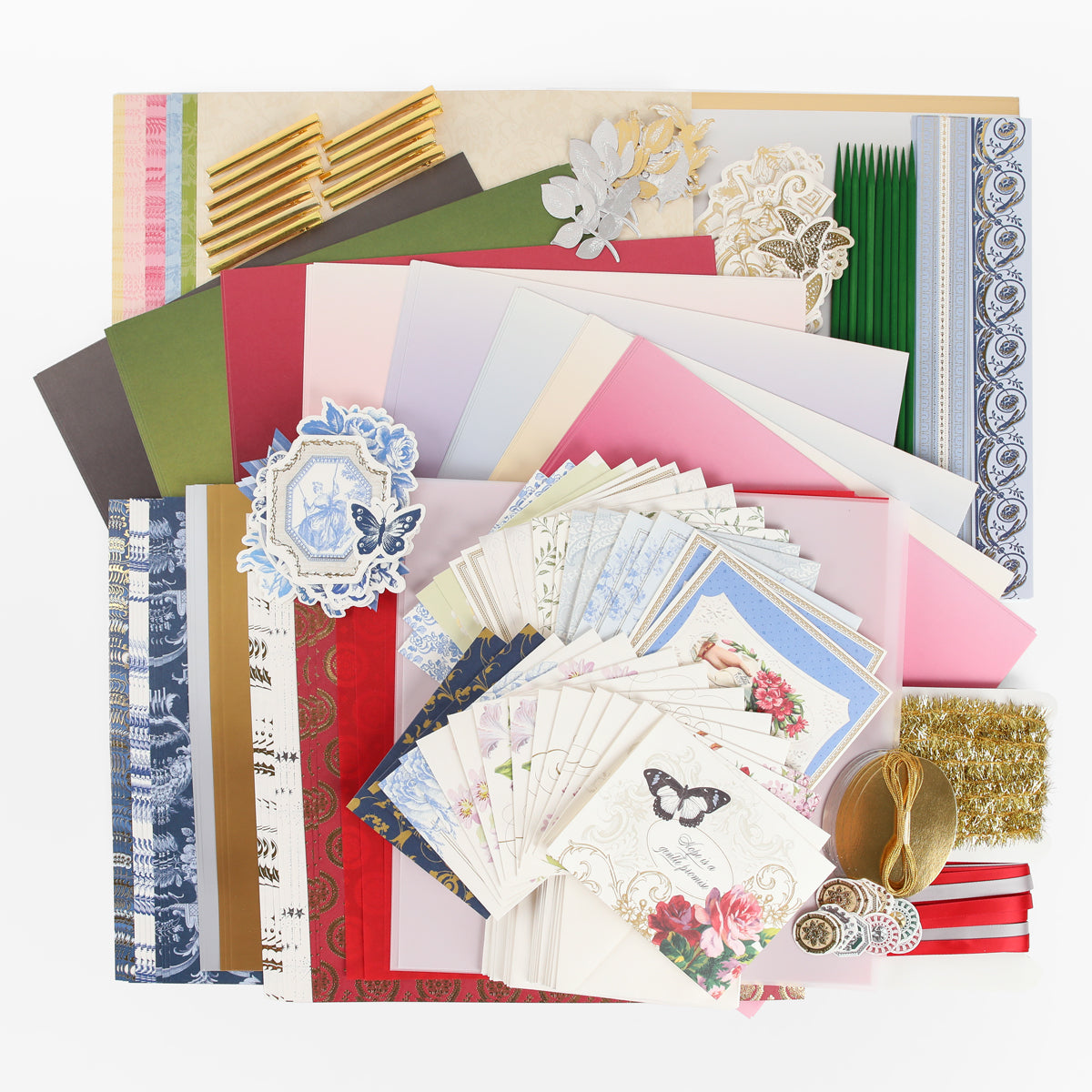 Assorted decorative paper, cards, envelopes, ribbons, lace, gold embellishments, and die-cut shapes from the Anna Griffin | Create Fall 2026 collection arranged on a white background—ideal inspiration for heritage crafts or scrapbooking and perfect for your upcoming crafting classes.