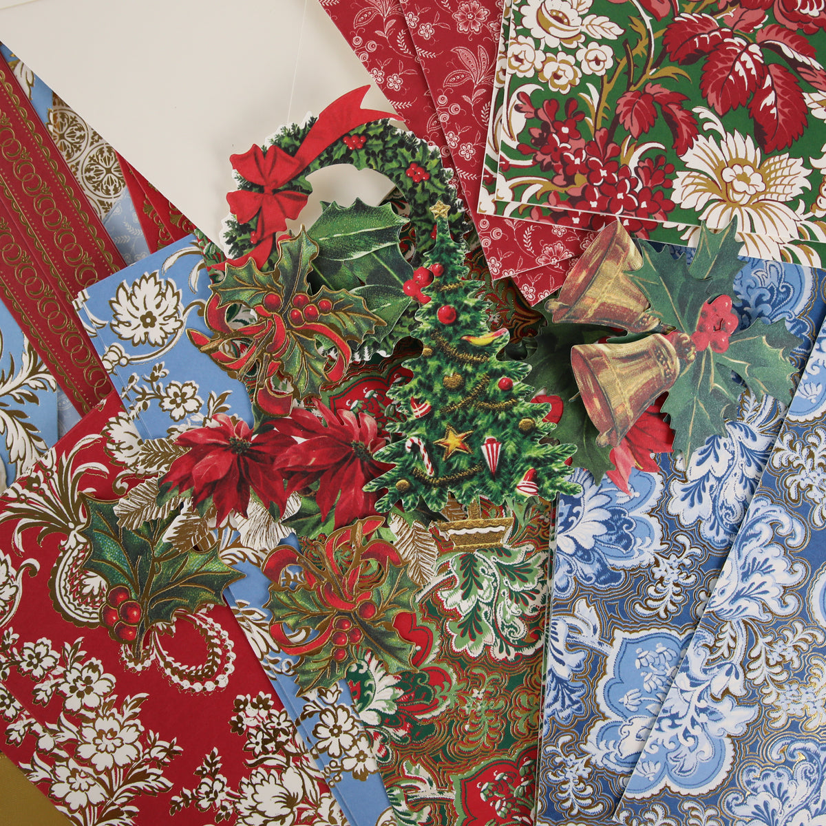 Anna Griffin | Create Fall 2026: Assorted vintage Christmas wrapping papers in red, blue, and green patterns, adorned with poinsettias, holly, ornaments, and golden bells—ideal for the creative community or those planning Fall 2026 craft classes.