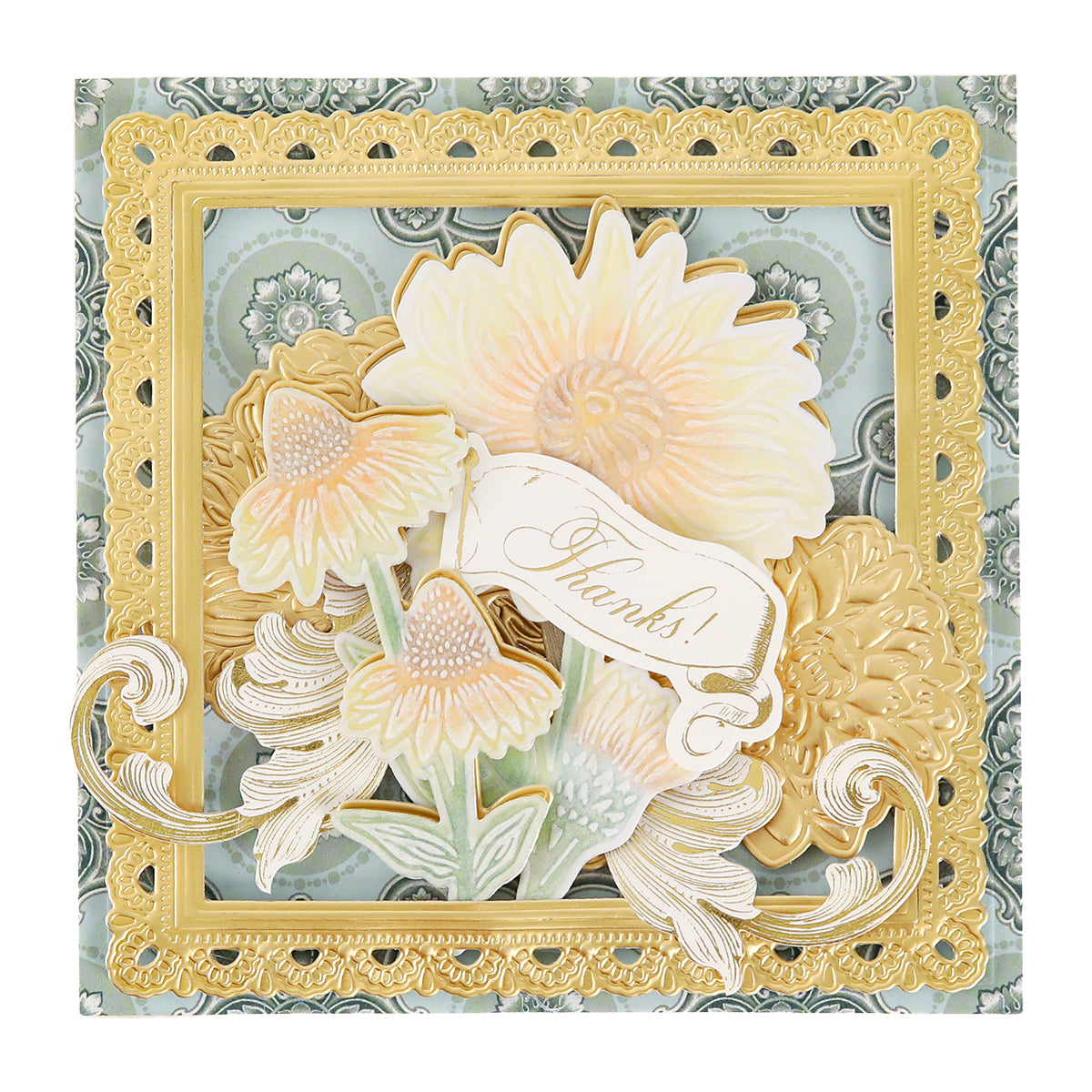 Greeting card created with the Dahlia, Mum and Sunflower 3D Floral Dies, showcasing intricate yellow and gold floral details within an ornate gold frame and a “Thanks!” banner, set against a patterned blue and green background.