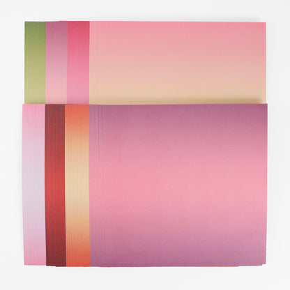 A stack of Perfect Petal Double Sided 12 x 12 Cardstock in pink, red, orange, and green—ideal for card making on a white background.