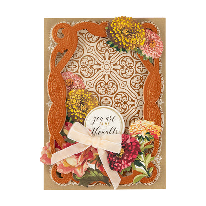 A decorative greeting card featuring Fall Flower Embellishments, an ornate orange frame, a pink bow, and a “you are in my thoughts” label on a patterned background.