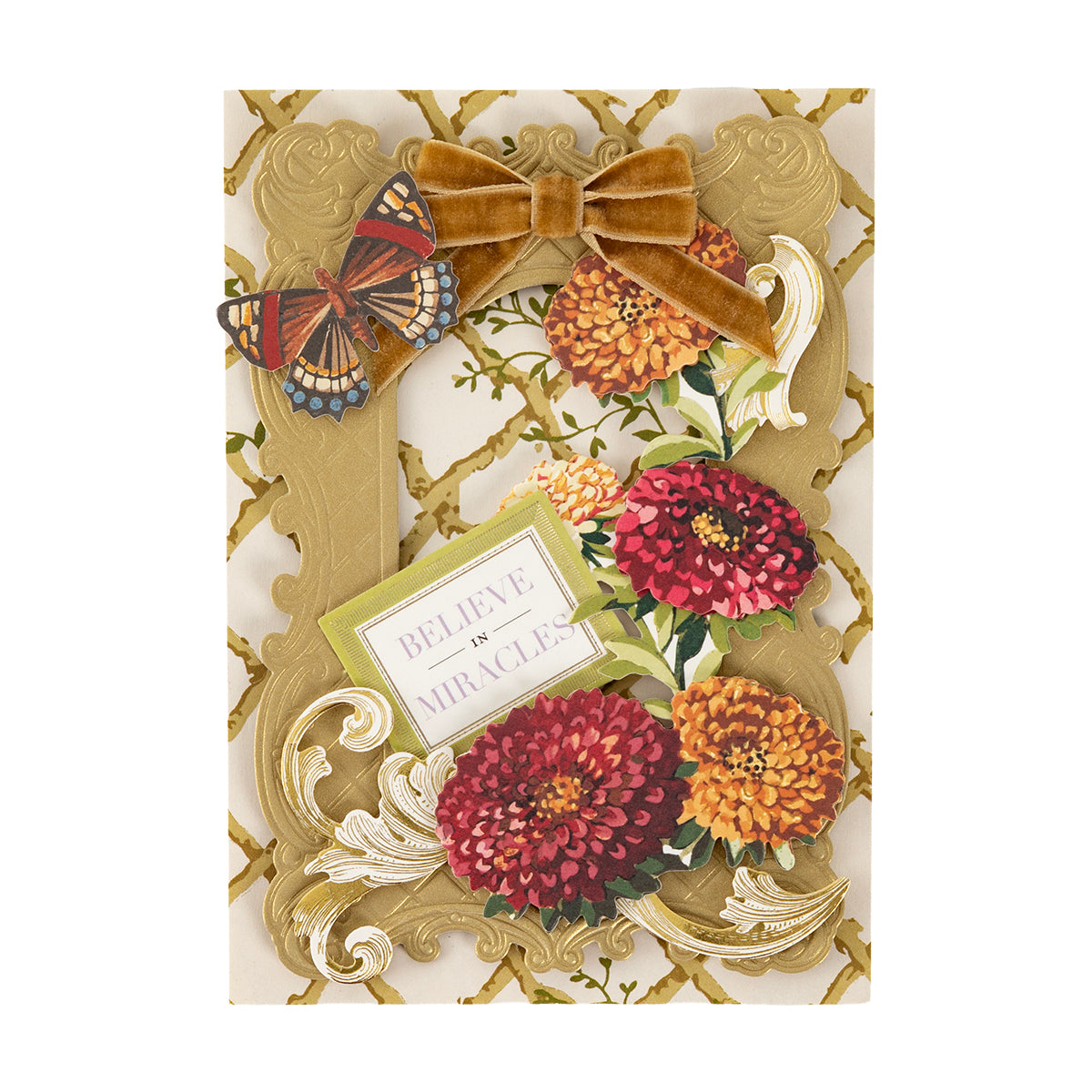 A decorative gold frame from the Fall Florals and Foil Bundles collection, overlaid on foil cardstock with paper flowers, a butterfly, a velvet bow, and a “Believe in Miracles” sign for autumn crafting.