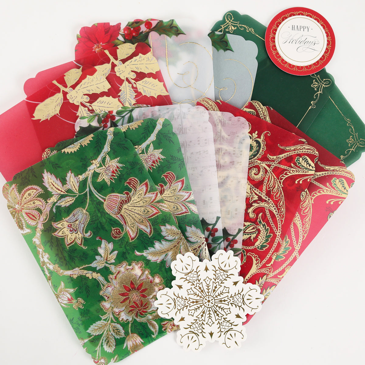 Simply Merry Christmas Card Making Kit: festive cards for the holidays with floral, leaf, and snowflake designs in red, green, and gold, arranged in a fan shape.