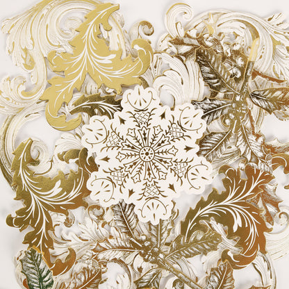 The Simply Merry Christmas Card Making Kit features gold and white paper cutouts with leaf and snowflake designs, perfect for your festive holiday card creations.