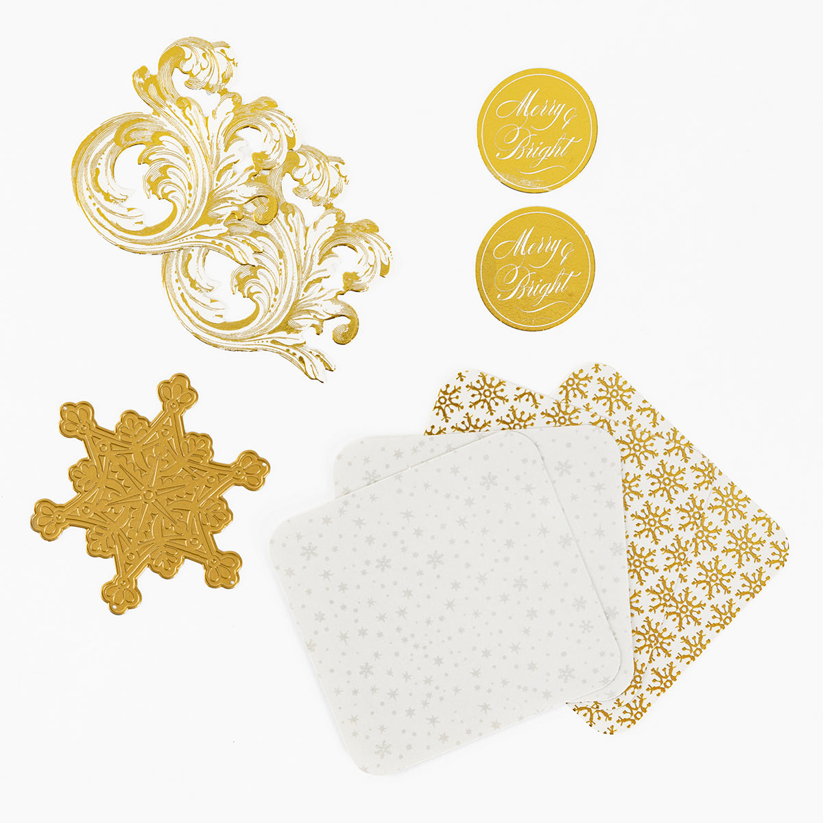 The Christmas Grace Advent Calendar includes gold and white paper items—swirls, snowflakes, coasters, and “Merry & Bright” stickers—ideal for crafts or holiday projects.