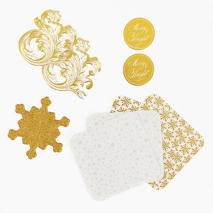 The Christmas Grace Advent Calendar includes gold and white paper items—swirls, snowflakes, coasters, and “Merry & Bright” stickers—ideal for crafts or holiday projects.
