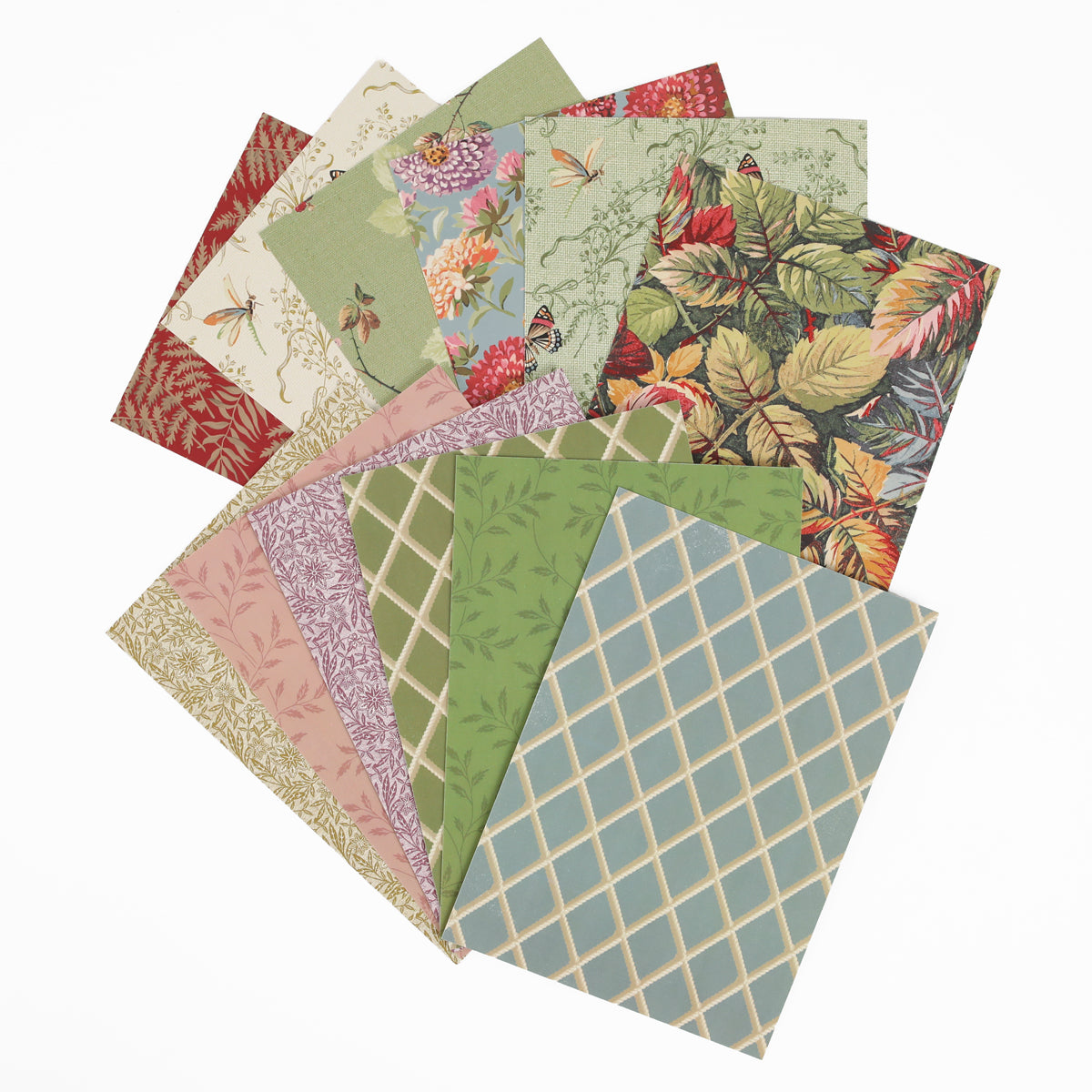 Ten patterned sheets of paper arranged in a fan shape, showcasing floral, leaf, grid, and nature-inspired designs in green, red, pink, beige, and blue tones—ideal for pairing with Sienna Folded Cards and Layers or 5″ x 7″ cards to elevate your next cardmaking project.