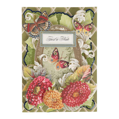 Featuring vibrant red and pink flowers, green leaves, and butterflies, the Sienna Folded Cards and Layers set includes 5″ x 7″ folded cards adorned with an ornate label that reads “Just a Note.” These charming cards are perfect for cardmaking projects and make it easy to send heartfelt messages.