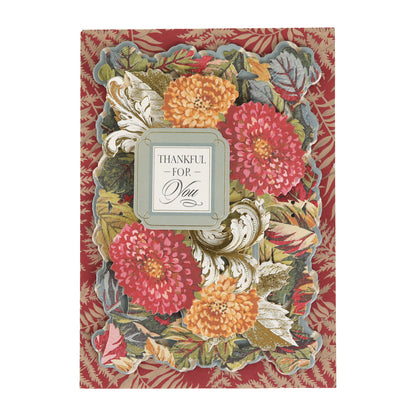 Send warm messages or craft beautiful cards with the Sienna Folded Cards and Layers, featuring a greeting card adorned with red, orange, and yellow flowers, green leaves, and a silver frame around the “THANKFUL FOR YOU” sentiment set against a red patterned background—perfect for elegant 5″ x 7″ creations.