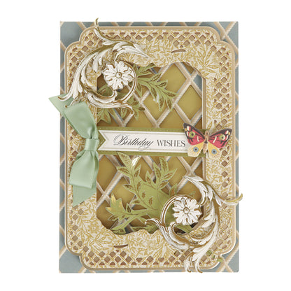 Featuring intricate gold floral patterns, a green ribbon accent, a delicate butterfly motif, and the phrase “Birthday Wishes” at the center, Sienna Folded Cards and Layers (measuring 5″ x 7″) are perfect for cardmaking enthusiasts seeking an elegant way to express heartfelt greetings.