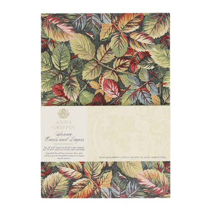 A pack of Sienna Folded Cards and Layers, ideal for cardmaking, features elegant 5″ x 7″ cards adorned with a colorful leaf pattern in green, red, and gold tones and includes product details on a cream label.