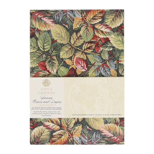 A pack of Sienna Folded Cards and Layers, ideal for cardmaking, features elegant 5″ x 7″ cards adorned with a colorful leaf pattern in green, red, and gold tones and includes product details on a cream label.