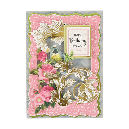 A decorative birthday card adorned with pink, gold, and green floral designs, featuring the text “Happy Birthday to You” in the center and enhanced by elegant Gold Foil Flourish Stickers for a sophisticated touch.