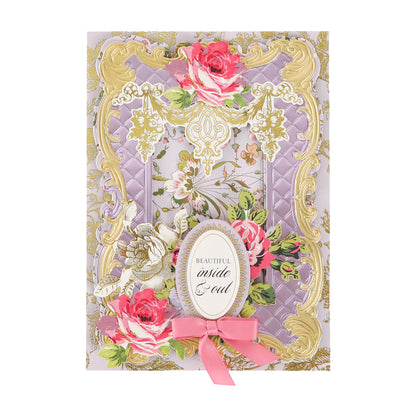 Adorned with gold foil flourish stickers, this decorative greeting card showcases elegant floral designs and a pink bow, centering the message “Beautiful inside & out.” Subtle scrapbook embellishments and metallic stickers provide an extra touch of sophistication to this charming design.
