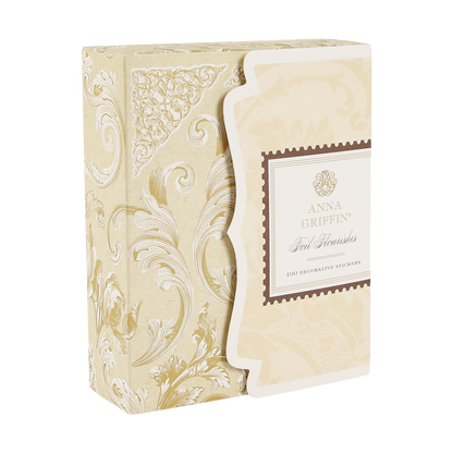 A decorative beige and gold box labeled “Gold Foil Flourish Stickers” containing 100 ornate metallic stickers, featuring elegant patterns—perfect for adding a sophisticated touch to scrapbook embellishments or any craft project.