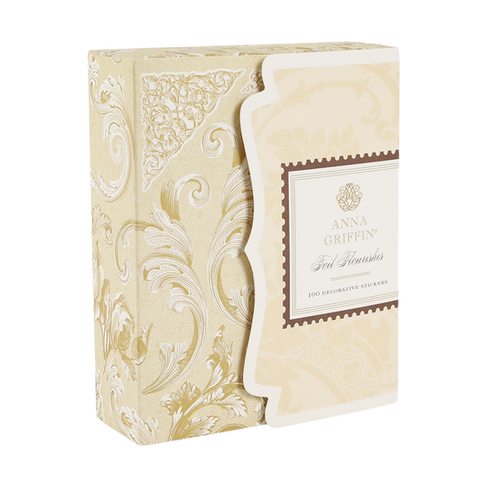 A decorative beige and gold box labeled “Gold Foil Flourish Stickers” containing 100 ornate metallic stickers, featuring elegant patterns—perfect for adding a sophisticated touch to scrapbook embellishments or any craft project.