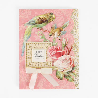 Celebrate any occasion with our Pretty Pattern A2 Cards and Envelopes, featuring a “Best Wishes” sentiment, two charming illustrated birds, pink and white roses, gold decorative details, and a cream ribbon bow set against a pink background. Each handmade card comes with a coordinating ivory envelope for an elegant finishing touch.