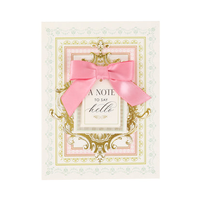 Introducing Pretty Pattern A2 Cards and Envelopes—handmade greeting cards featuring ornate gold and pastel borders, a striking pink ribbon bow, and the message “A Note to Say Hello” elegantly centered on each card. Every Pretty Pattern A2 Card comes paired with an elegant ivory envelope, creating a truly special way to send your warmest greetings.