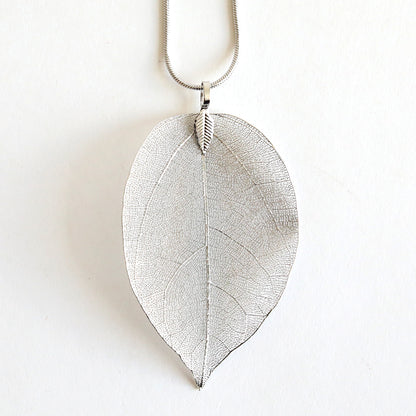 A set of two silver-tone leaf pendants featuring a detailed vein pattern on a simple chain, ideal for creating your own necklace kit, showcased on a white background.