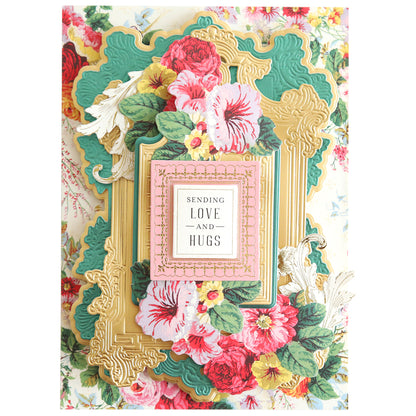 A decorative card made from the Foil Matte Cardstock - Paris Green, featuring layered frames in gold and green hues, adorned with pink and red floral designs. At its center, the text "Sending Love and Hugs" adds charm to these exquisite 12" x 12" sheets.