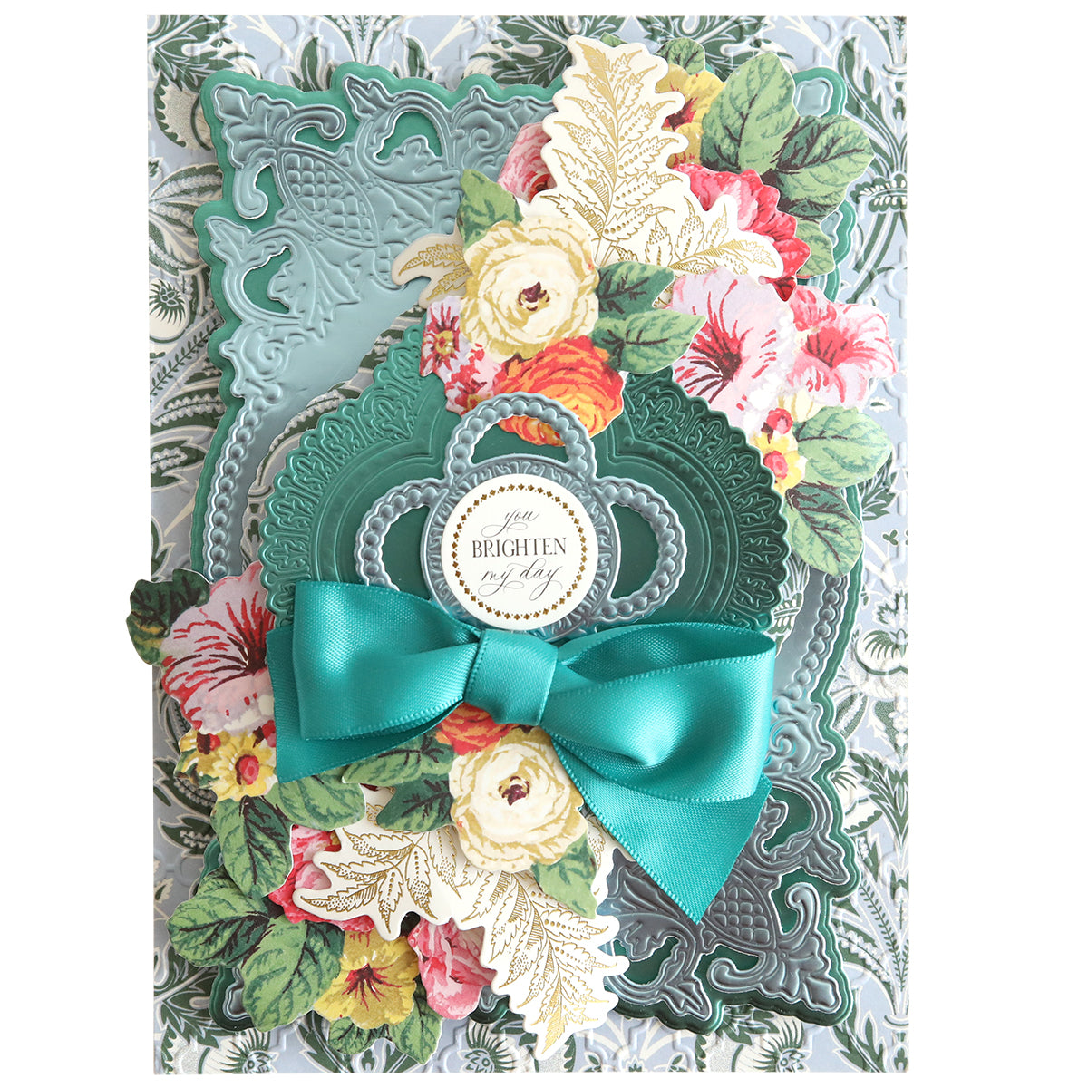This elegantly crafted design features intricate floral cutouts layered on a backdrop made from Paris Green foil matte cardstock. Adorned with a teal bow and vibrant flowers, it beautifully displays the "You Brighten My Day" message against the 12" x 12" sheets.
