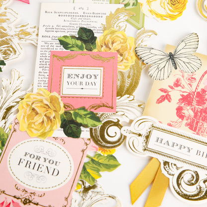 A flat lay of Birthday Collage Card Toppers features decorative floral cards and tags with messages such as “ENJOY YOUR DAY” and “FOR YOUR FRIEND,” accented by yellow roses, butterfly illustrations, and charming die cut details for an elegant vintage collage embellishment style.