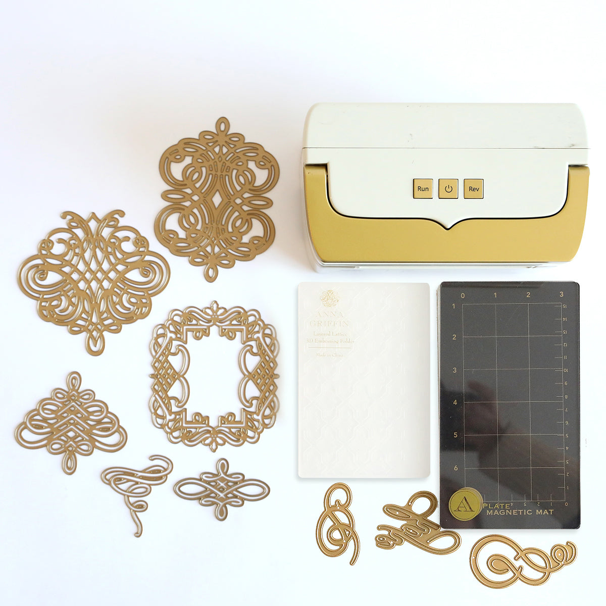 The Black Friday Empress Mini Bundle features a sleek mini die cutting and embossing machine, artfully accompanied by gold die cut designs, a white embossing folder, and a black magnetic mat.