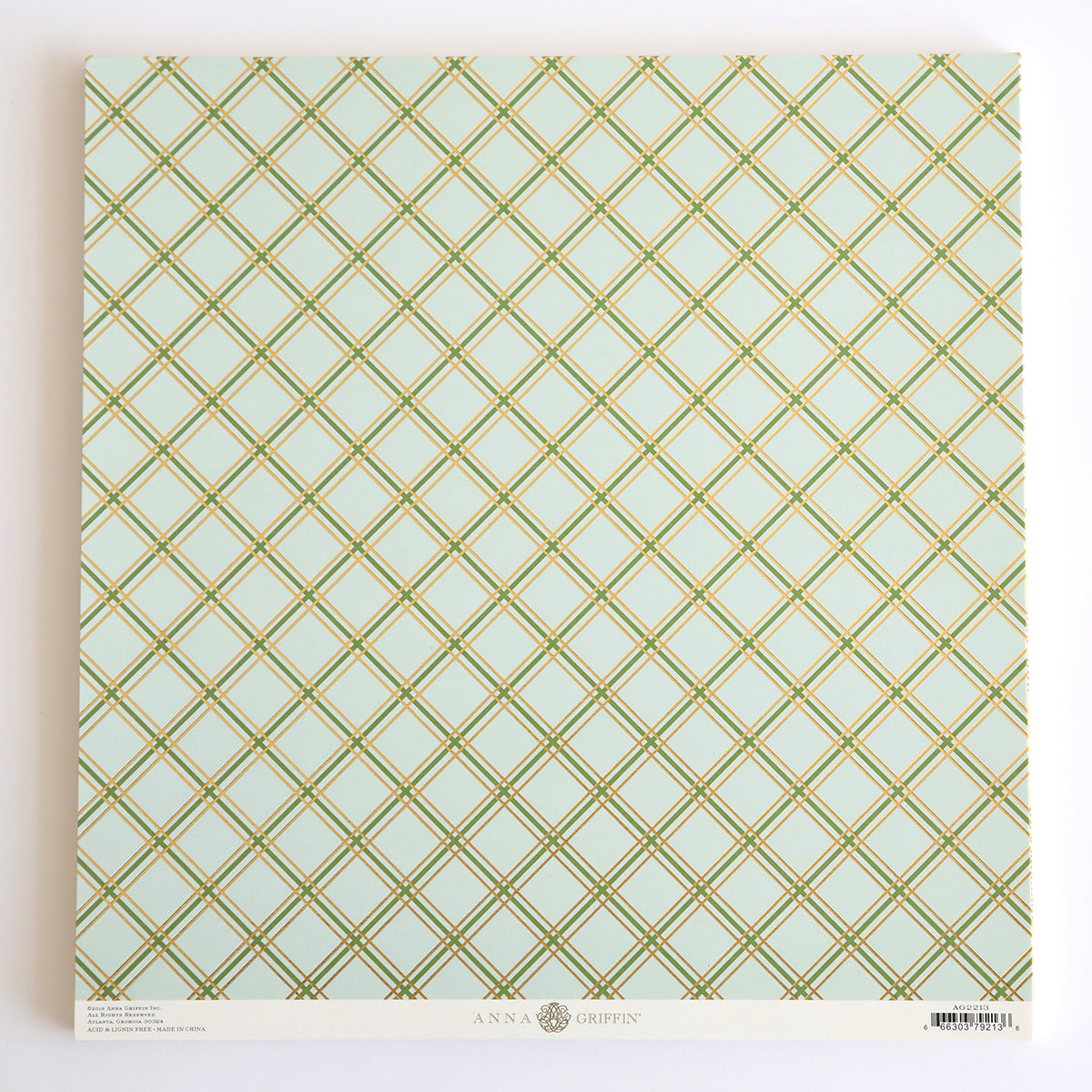 The 12x12 cardstock sheet titled "Pastel Plaid" displays a green and gold diamond plaid design with elegant gold foil, and "Anna Griffin" is printed at the bottom.