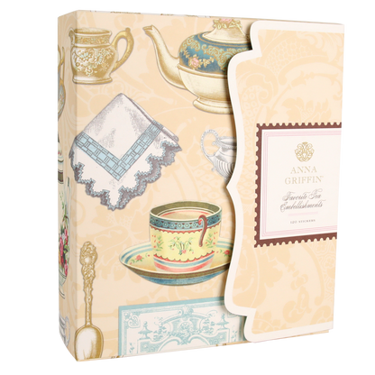 Box featuring vintage tea set illustrations and labeled “Favorite Tea Embellishments 120 Count” on a scalloped flap, set on a cream-colored background with tea-themed artwork—ideal for adding handmade card embellishments or antique-style tea stickers to your creative projects.
