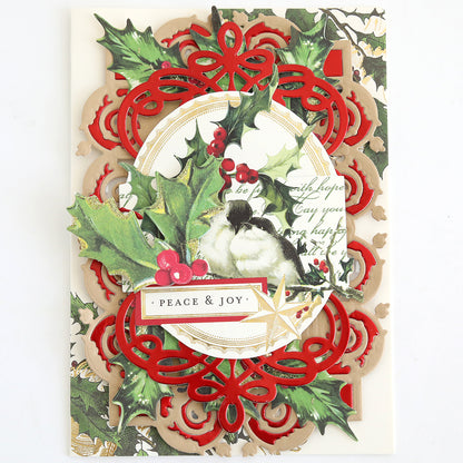 The Christmas Engravings Collage Card Toppers feature a beautifully designed bird surrounded by holly leaves, red berries, and intricate red and gold patterns, with a “PEACE & JOY” label at the center—ideal for creating handmade Christmas cards or adding an elegant touch to your festive projects.