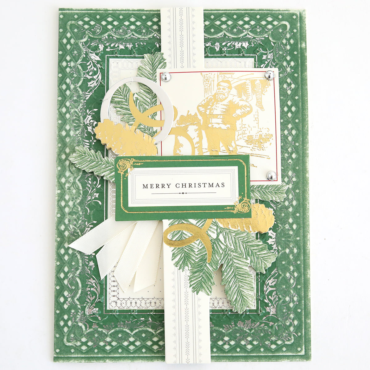 Celebrate the season with this green and cream handmade Christmas card, embellished with layered paper designs, leafy accents, ribbon details, and a central “Merry Christmas” greeting. Featuring an elegant vintage illustration of a man in gold and white, the card is adorned with Christmas Engravings Collage Card Toppers for a beautifully charming holiday touch.