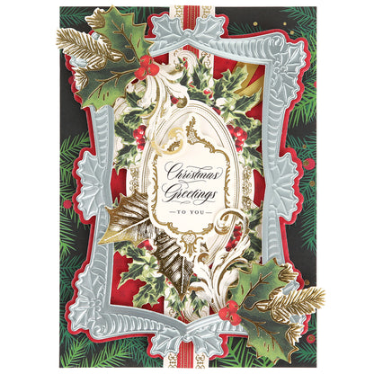 Ornate Christmas card crafted with Ice Blue Foil Cardstock Bundle, adorned with holly, gold accents, and a silver frame, reads "Christmas Greetings to you" on a red and green festive background.