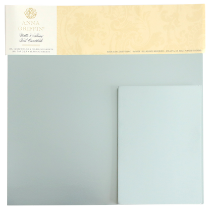 A set of Ice Blue Foil Cardstock Bundle sheets by Anna Griffin, displayed in their original packaging with a decorative beige label at the top. This collection includes both shiny foil and matte cardstock finishes, making it perfect for enhancing your creative projects.
