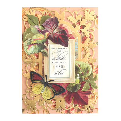 Greeting card embellished with Foliage Stickers, featuring an ornate gold design, colorful autumn leaves, and a yellow butterfly in 3D. Displays the message: “Give thanks for a little and you will find a lot.”.