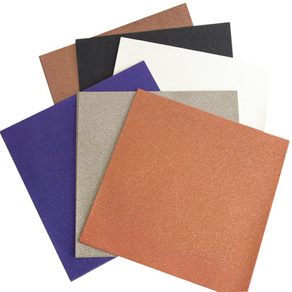Six square sheets of glittery craft foam—in brown, black, white, purple, silver, and orange—are fanned out in a stack from the Haunted Halloween Haul set. Perfect for DIY spooky creations, these sheets pair perfectly with glitter cardstock or Halloween stickers to add extra festive flair!.