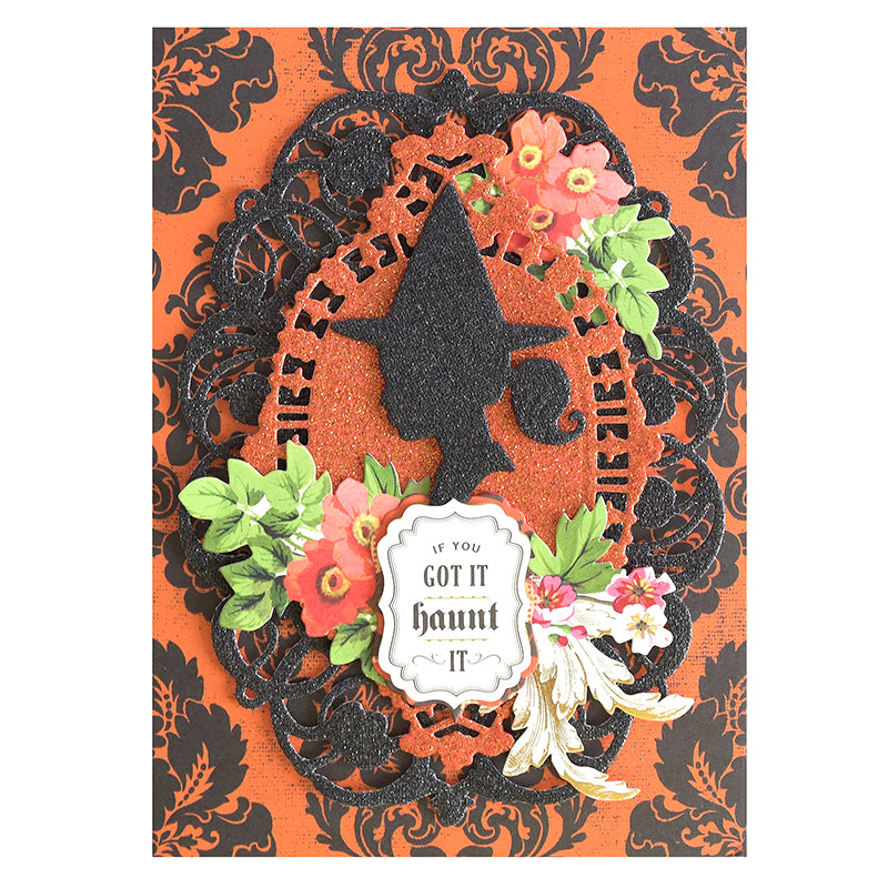 The Haunted Halloween Haul features an orange and black card adorned with a witch silhouette, floral accents, and the phrase “If you got it haunt it” at the center, all surrounded by ornate patterns and crafted on glitter cardstock for extra sparkle—an ideal addition to your Halloween craft supplies.