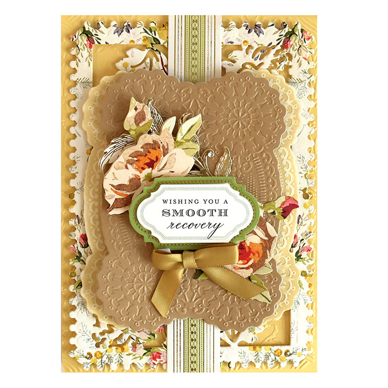 A get well card created using Harvest Cut & Emboss Folders showcases intricate floral decorations and a gold bow, with beautifully embossed layers. The card reads, "Wishing You a Smooth Recovery.