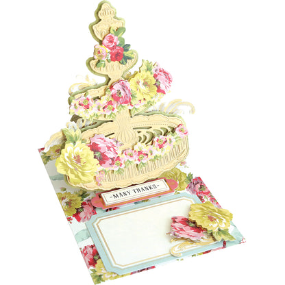 The Anna Griffin craft box includes an interactive Garden Fountain Easel Finishing School Kit with beautiful flowers on it.