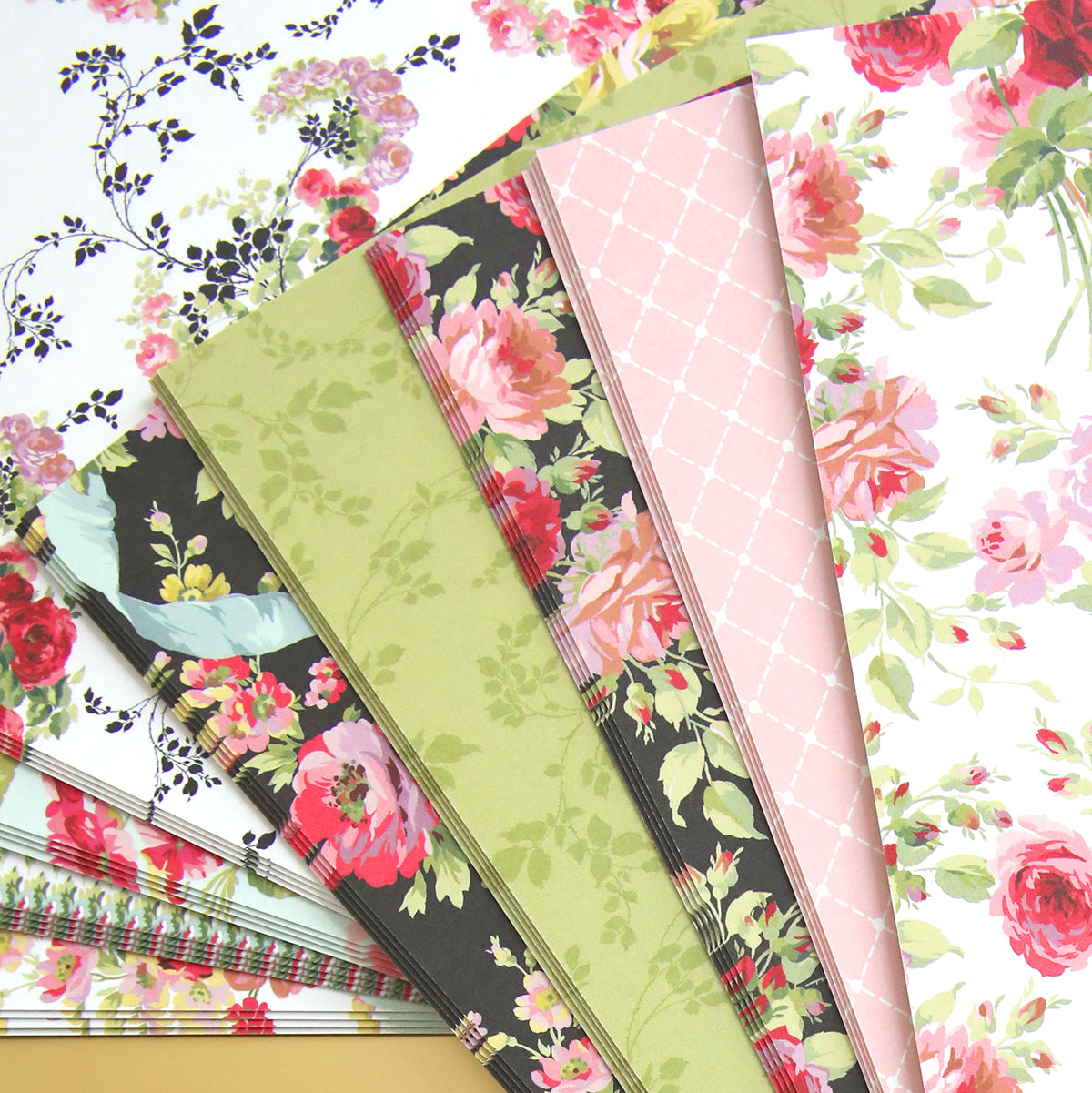 A stack of Garden Fountain Double Sided Cardstock layers with beautiful floral designs, perfect for paper crafting enthusiasts or fans of Garden Fountain.